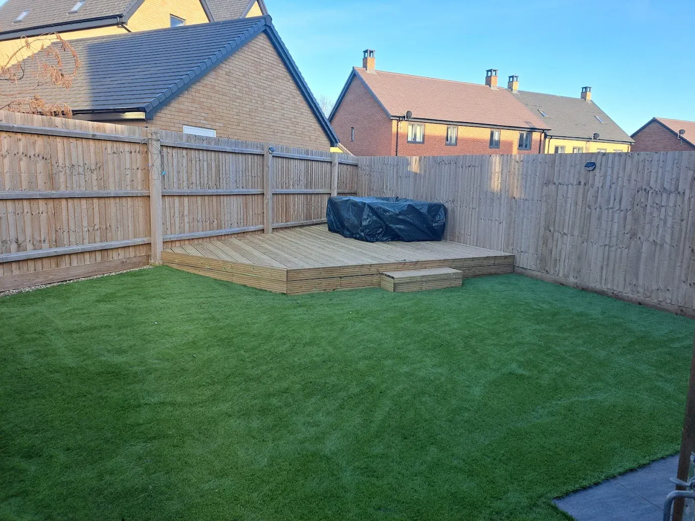Modern garden with artificial grass and wooden fencing in Dunstable - Professional landscaping by Fence & Garden Designs