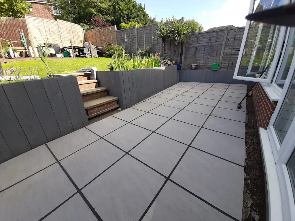 Split-level patio with retaining wall and paving in Bedfordshire - Professional landscaping services